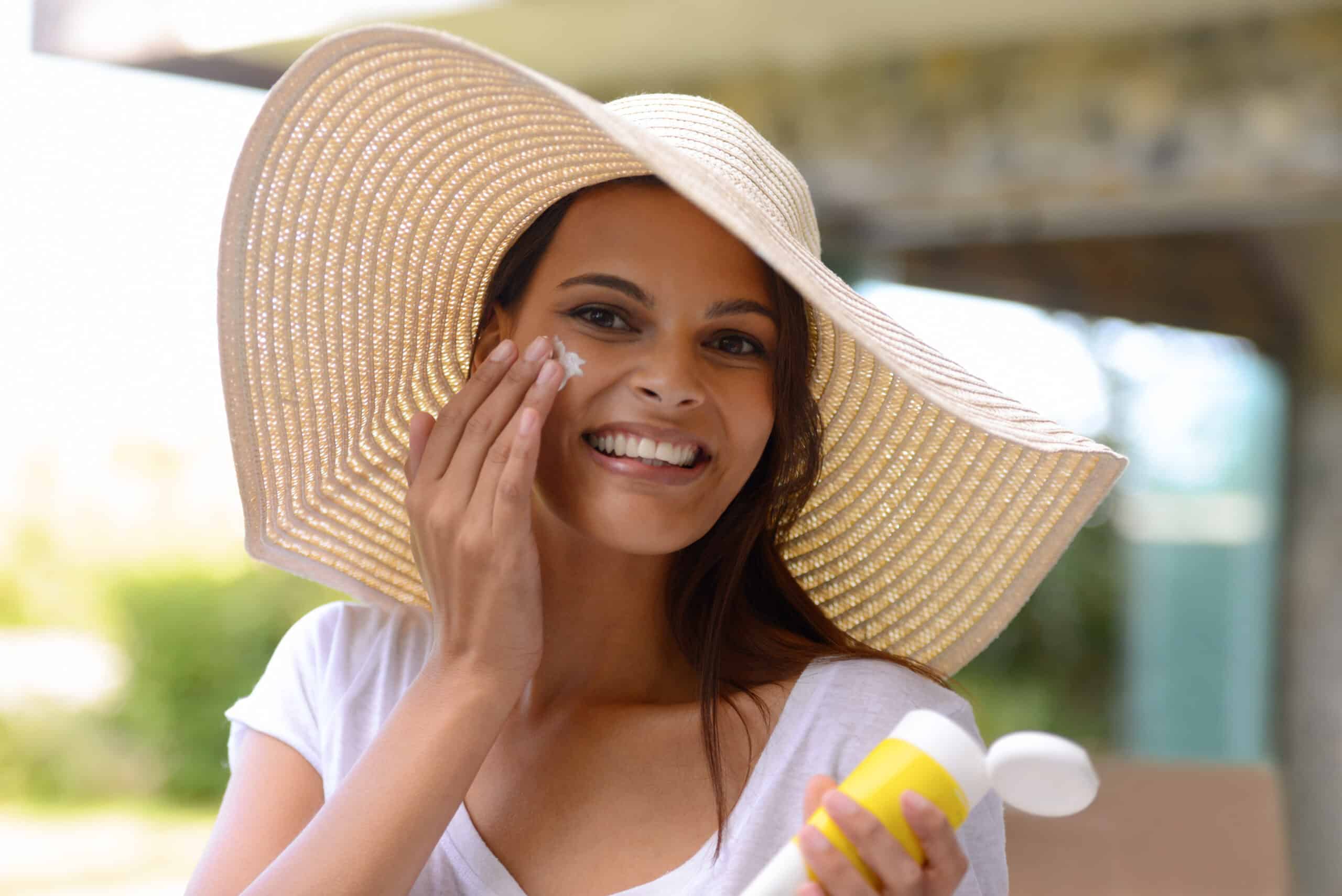 Better safe than sorry. An attractive young woman applying sunscreen to her face